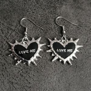 "LOVE ME" 2 sided spiked heart-shaped black and silver earrings